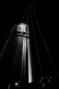 Low angle view of illuminated bridge against sky at night