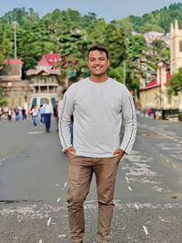 Portrait of man standing on road