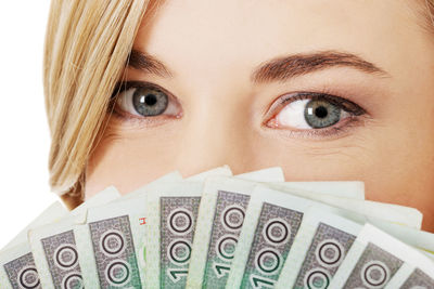 Woman with paper currency against white background