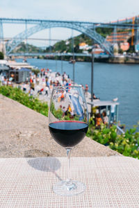 Wine in glass on table by boat