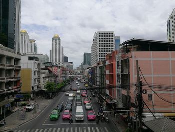 High angle view of city street and buildings against sky