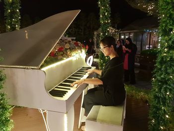 Low angle view of woman playing piano