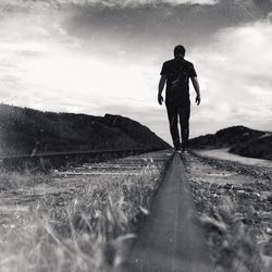 Full length of woman standing on mountain landscape