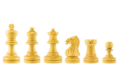 Low angle view of chess pieces against white background