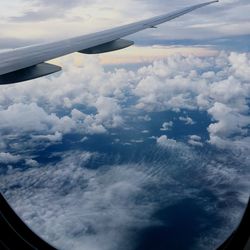 Aerial view of cloudscape over airplane wing