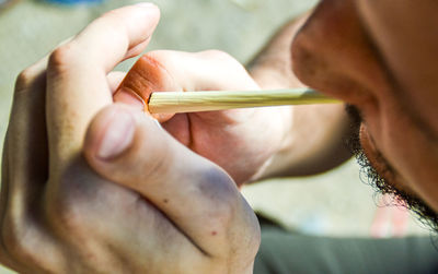 Close-up of man burning marijuana joint