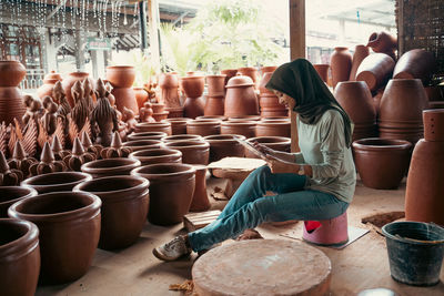 Rear view of woman working on table