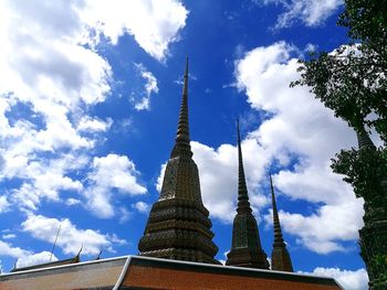 Low angle view of temple against cloudy sky