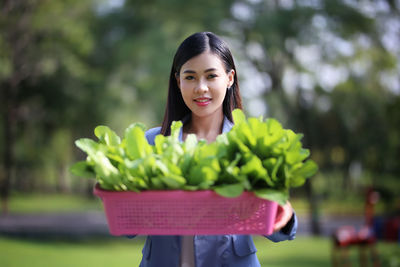 Portrait of a smiling young woman standing outdoors