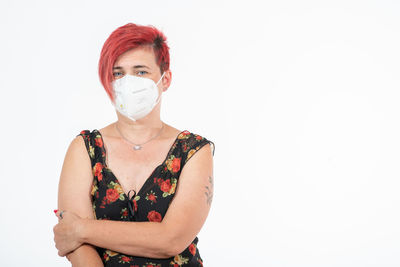 Portrait of woman standing against white background