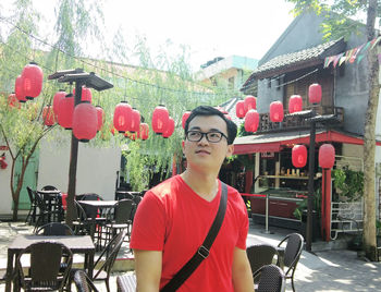 Full length of young man standing against built structure