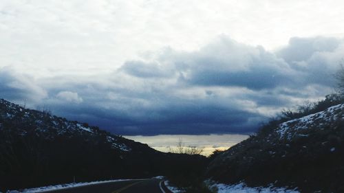 Scenic view of mountains against cloudy sky