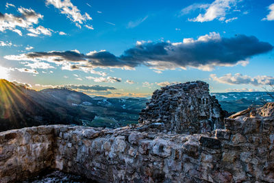 Rock formation against sky during sunset