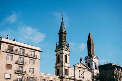 Low angle view of buildings against blue sky