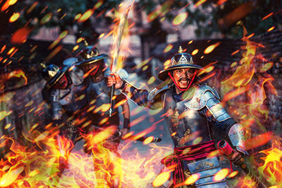 Digital composite image of fire and fighting warrior