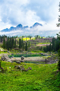 Scenic view of carezza's lake under a careful eye of the mountains. 