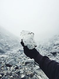 Cropped image of person holding ice