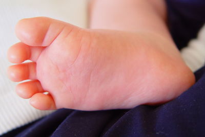 Low section of baby on bed