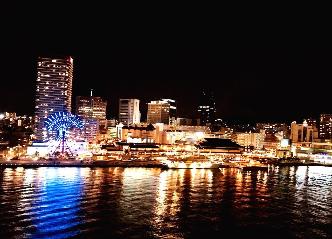 ILLUMINATED BUILDINGS AT WATERFRONT