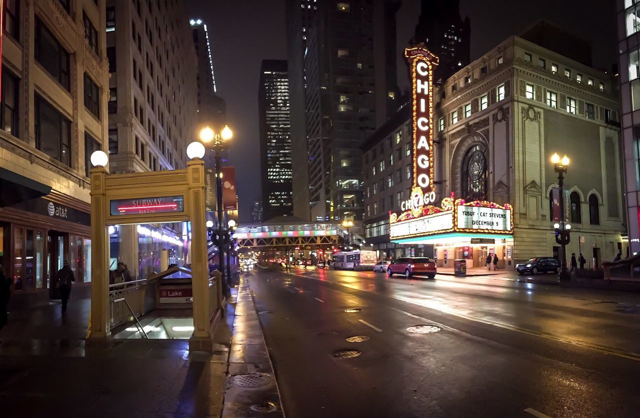 illuminated, night, building exterior, architecture, city, built structure, street, transportation, street light, city street, city life, road, car, building, lighting equipment, road marking, office building, outdoors, land vehicle, incidental people