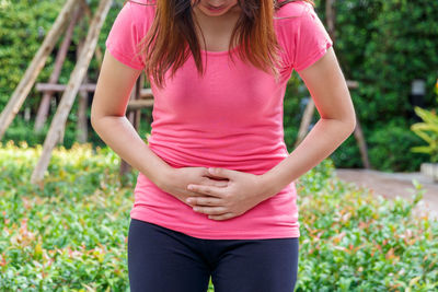 Midsection of woman with pink hair