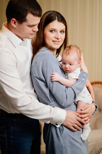 Cheerful mother with husband and son at home