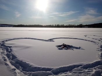 Scenic view of frozen lake against sky during winter