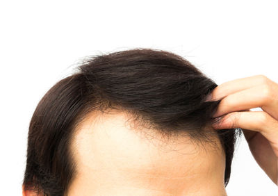 Woman looking away against white background