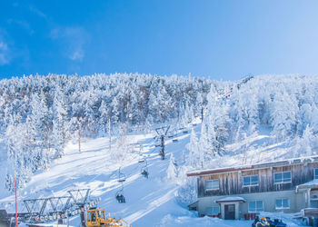 Scenic view of snowcapped mountains against clear blue sky