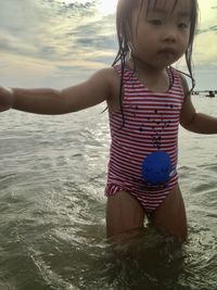 Cute girl playing in water at beach