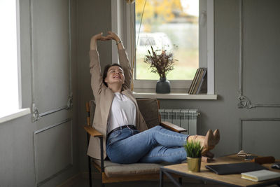 Stretching  moment, snapshot of leisure, where time slows down, woman takes pause from digital world  