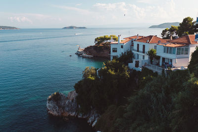 High angle view of buildings by sea against sky