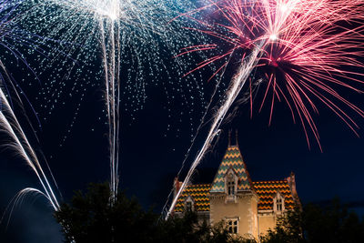 Low angle view of firework display at night