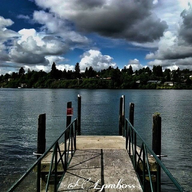 PIER ON LAKE AGAINST CLOUDY SKY