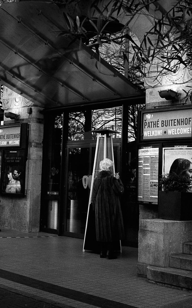 Street Monochrome monochrome photography Snapshot Urban Area One Person Day Cinema Theatre Fur Coat Smoking - Activity Film Posters