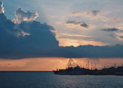 Ship sailing on sea against sky during sunset