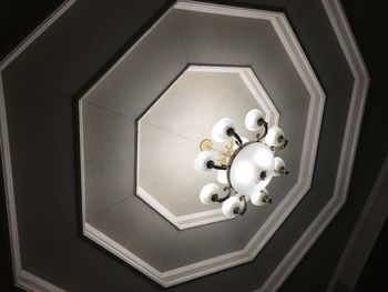 Low angle view of electric lamp hanging on ceiling
