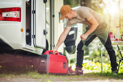 Side view of man working on field