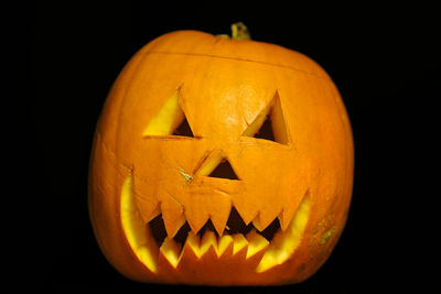 Close-up of illuminated pumpkin against black background