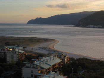 High angle view of beach by city against sky