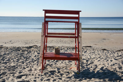 Lifeguard hut on beach against clear sky