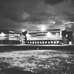View of illuminated buildings against cloudy sky