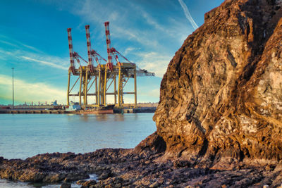 Commercial dock by sea against sky