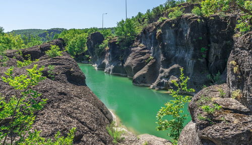 Scenic view of waterfall against sky