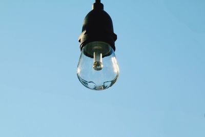 Low angle view of light bulb against clear sky