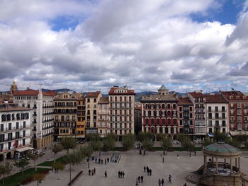 Panoramic view of people in city against sky