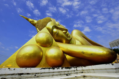 Low angle view of statues against sky