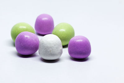 Close-up of multi colored candies against white background