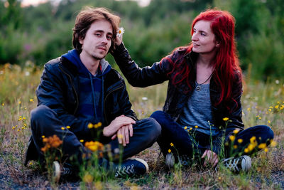 Young couple sitting outdoors