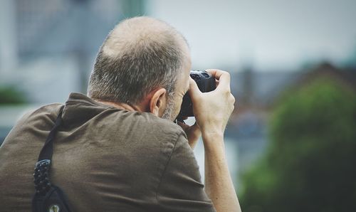 Rear view of man photographing